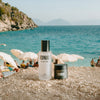 IONIC products on a beach with people and umbrellas in the background