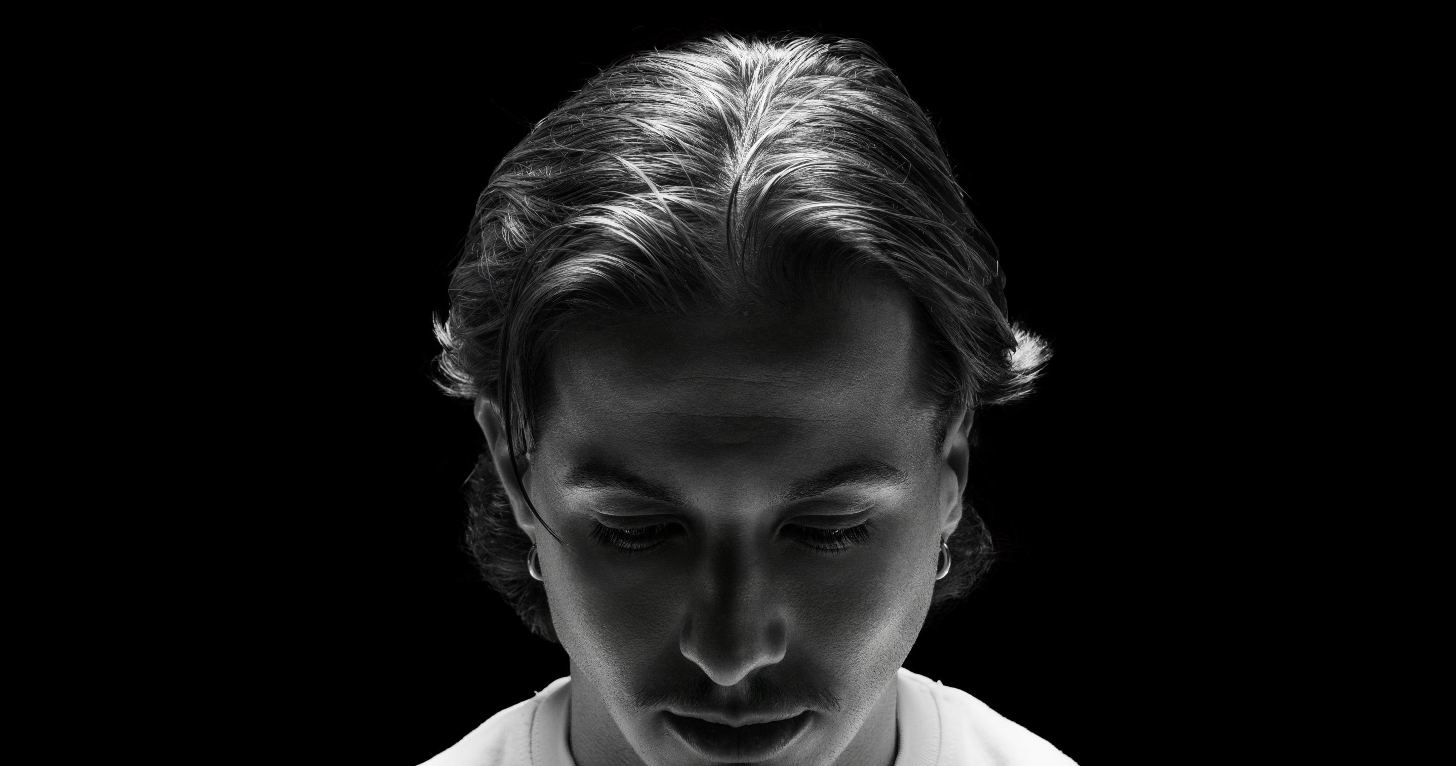 Black and white portrait of a person with a dark background